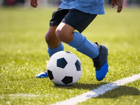 A young player at a soccer practice. 