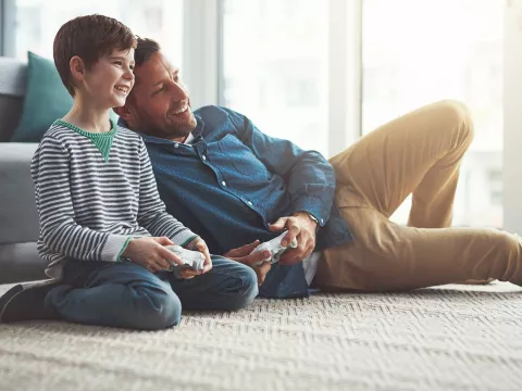 A father and son playing video games.