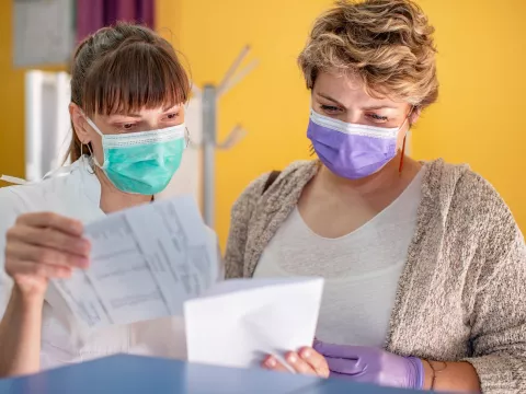 A doctor and patient looking at a medical chart. 
