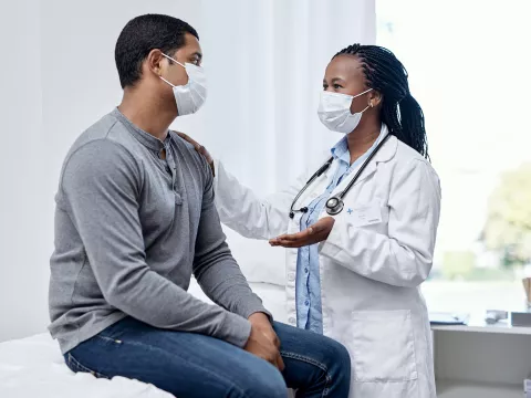 A physician discussing something to her patient