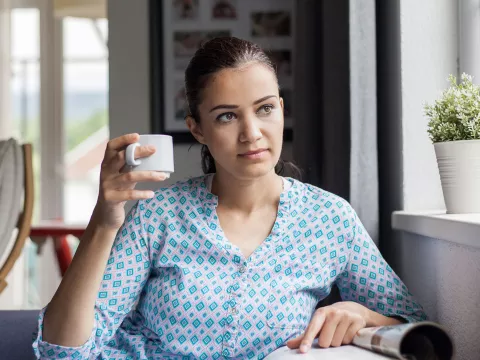 A woman sitting by the window.