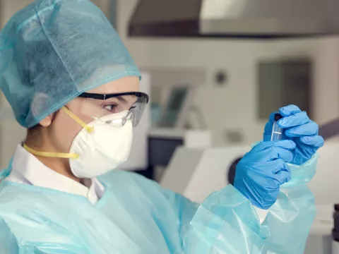 A woman analyzing a test sample. 