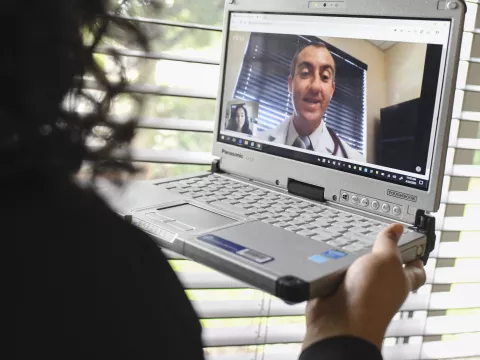 A woman has a video visit with her AdventHealth doctor. 