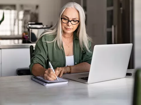 Woman with planner and laptop.