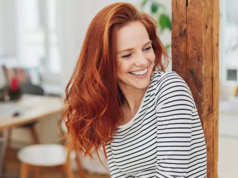 Woman with red hair smiling.