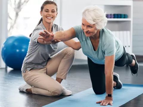 A woman works with a physical therapist.