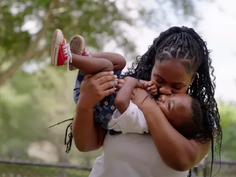 A woman holding her young son.