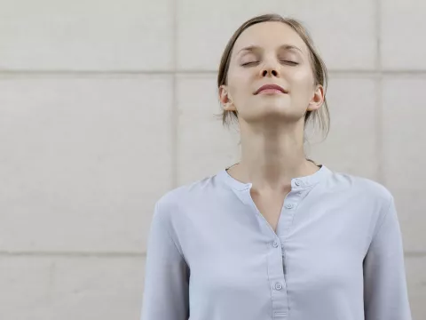 A woman takes a deep breath to stay calm during a lab test