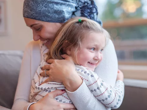 A mother and daughter hugging.