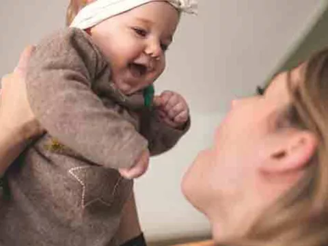 mom-lifts-up-baby-laughing