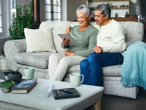 hispanic couple sitting in their home