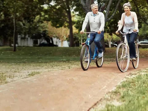 Old Couple Riding Bikes