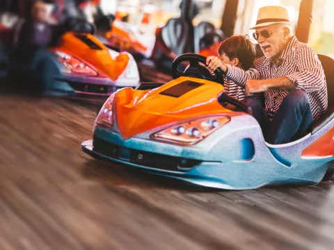 Grandfather and grandson in bumper car