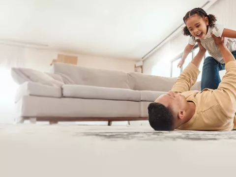 Family at home playing in living room