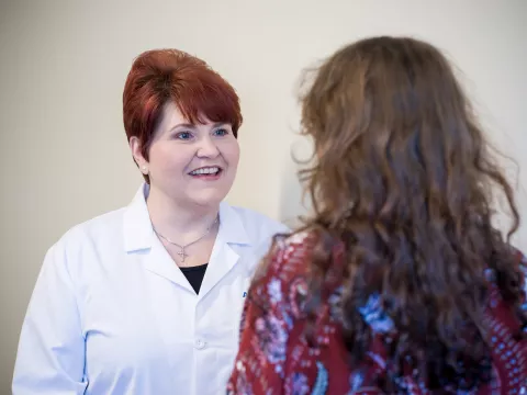 M. Lynn Herring speaks with a patient about her health.