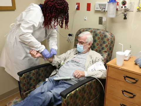 Nurse administers monoclonal infusion to patient