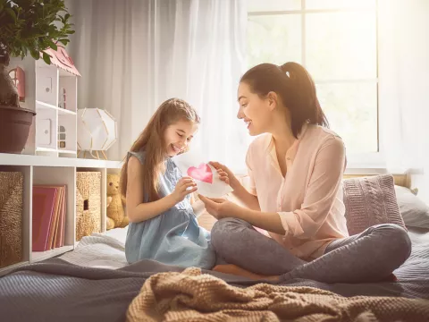 Mother and daughter share a loving card.