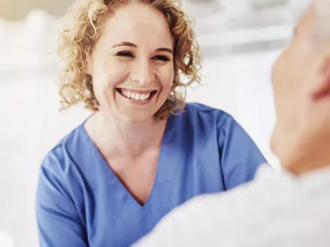 Nurse smiling at an elderly patient