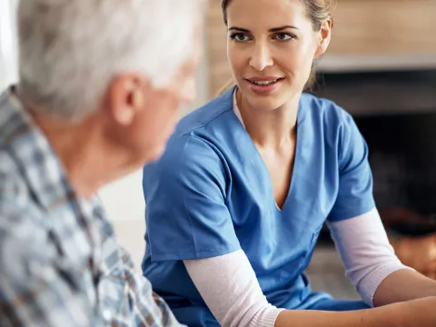 Nurse speaking with an elderly patient