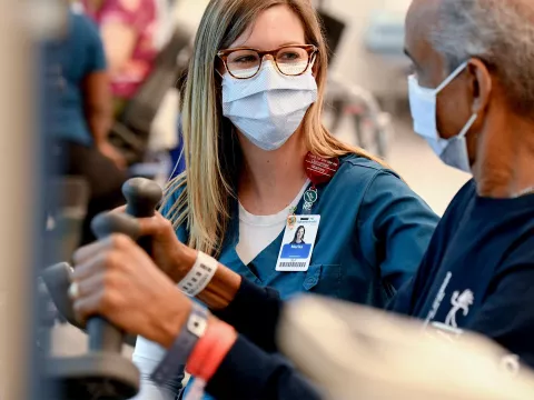 A nurse works with an older patient.
