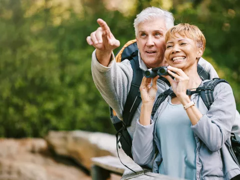 Older couple bird watching together.