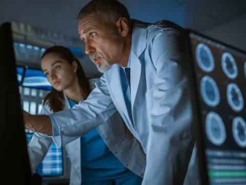 Physicians looking at a computer screen