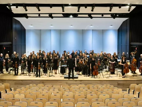 AdventHealth Orchestra on an indoor stage.