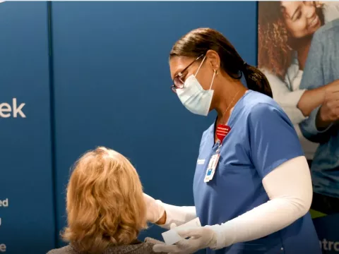 AdventHealth employee administers a COVID19 test to patient