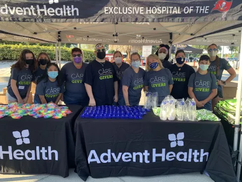 A group of masked volunteers posing for a photo