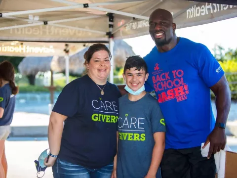 Three volunteers pose for a photo
