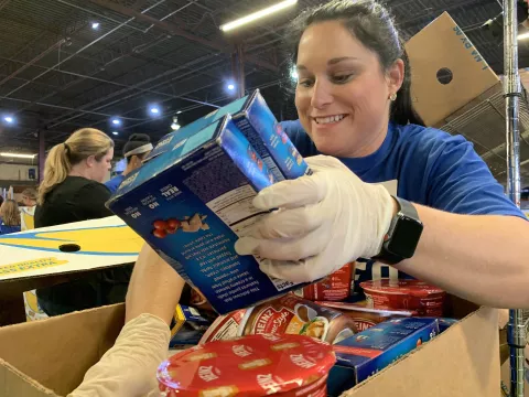 A woman holding boxes of food