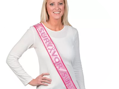 Woman wearing breast cancer survivor sash