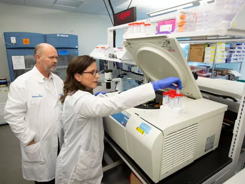 dr prayley looking over a study