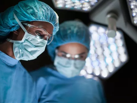 Two surgeons wearing masks in the operating room