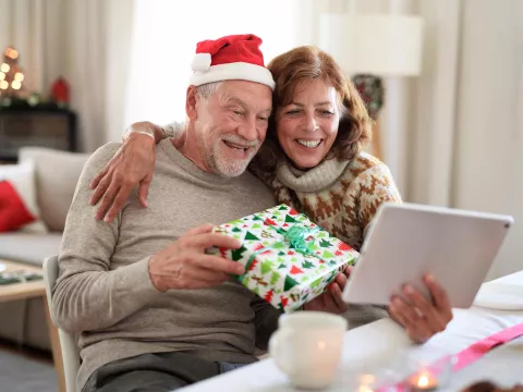 senior couple at home on a Christmas video call with the family