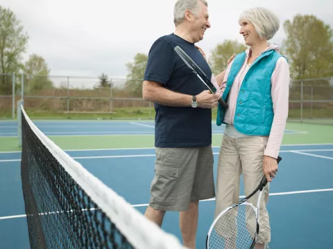 Senior couple playing tennis