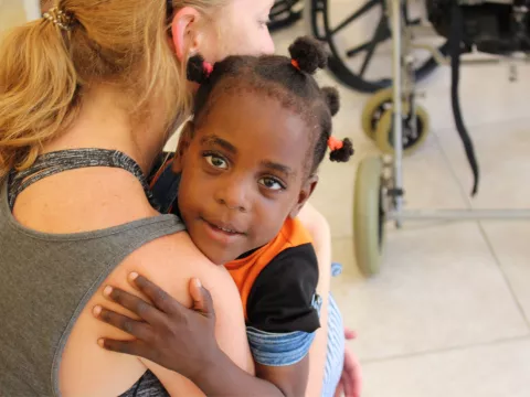 Woman holding a small child.