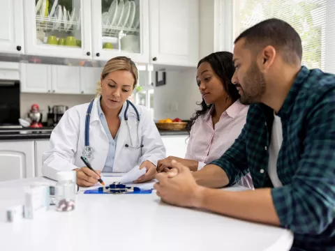 A couple talks to their doctor about fertility.