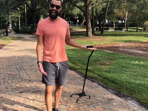 Brandon walking with his cane