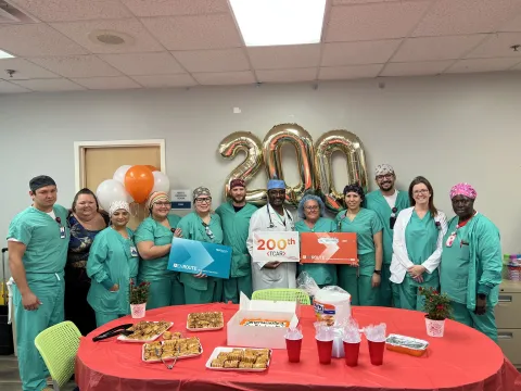 Dr. Myron St. Louis (middle holding 200th sign) was honored for completing his 200th TCAR surgery.