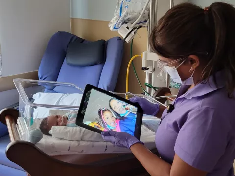 Amrita Budhu, virtual connections specialist, facilities a virtual visit for the Williams family.