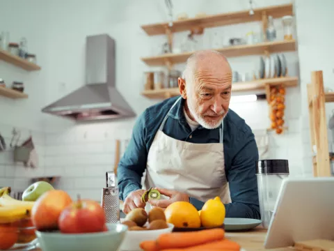 Older man preparing a healthy meal.