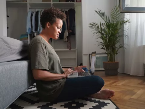 A woman doing research on her computer.