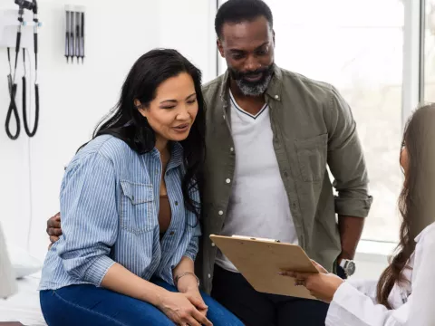 A couple talks with their doctor about family planning.