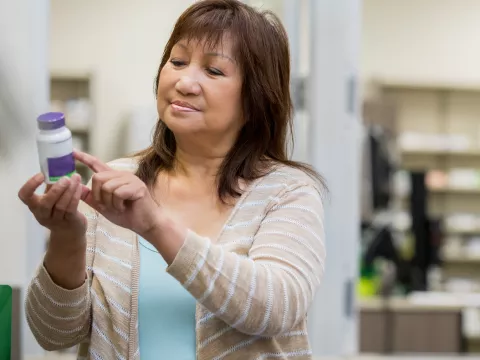 Woman holding medicine bottle