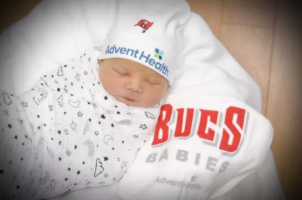 A 2021 newborn baby having clothes that show support for the Tampa Bay Buccaneers