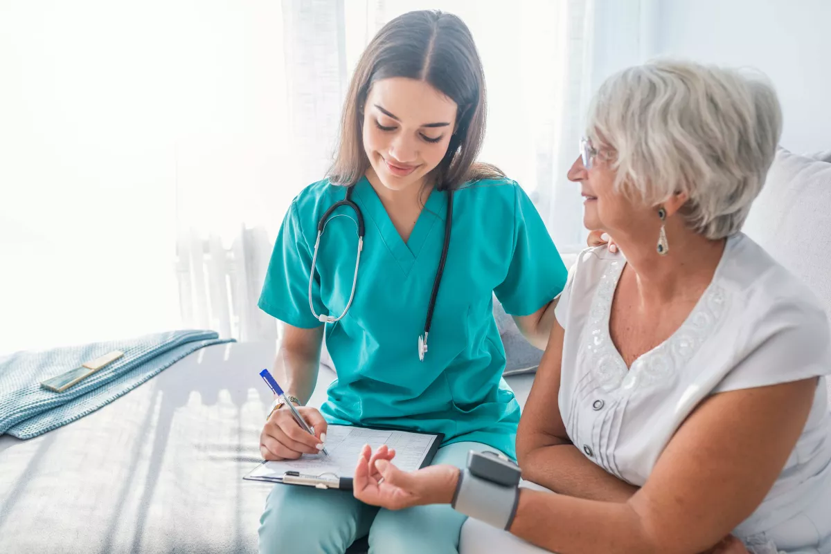 Nurse checking patients blood pressure.