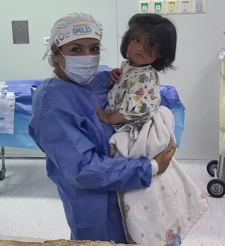 Maria Rodammer holding a child