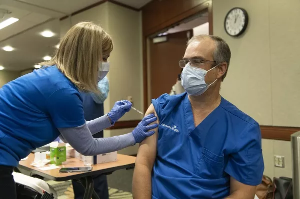 Dr. Oliveira receives a COVID-19 Vaccination at AdventHealth Orlando