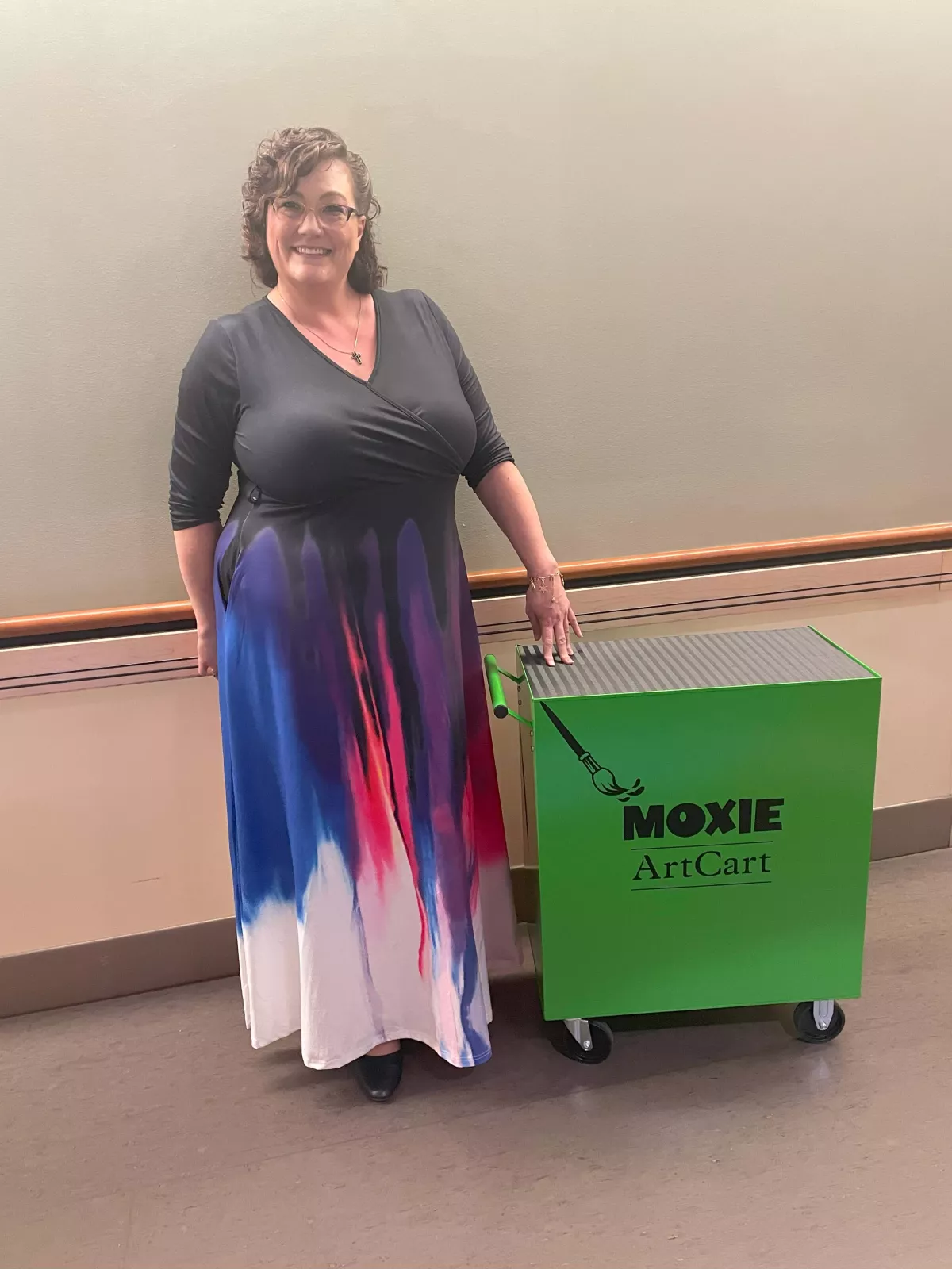 Marie Williams poses with the art cart